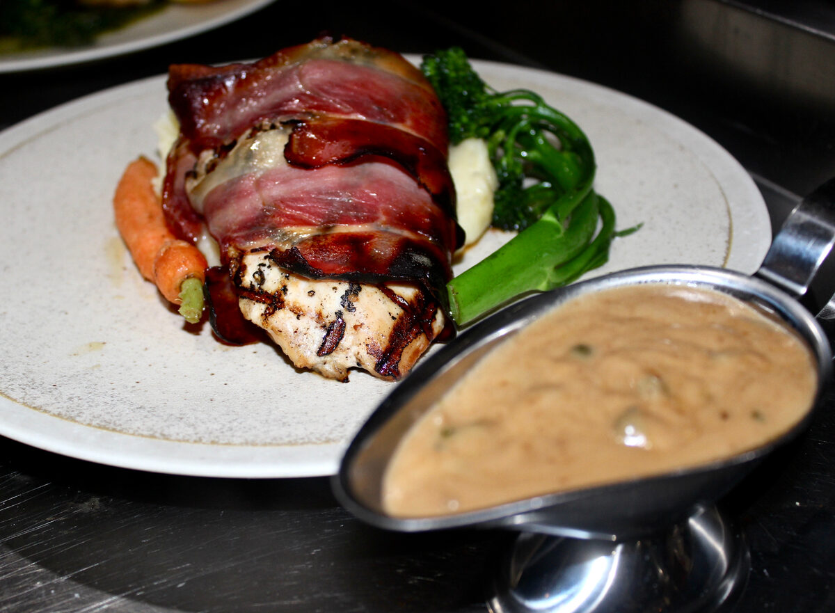 Prosciutto-wrapped chicken breast with mushroom gravy