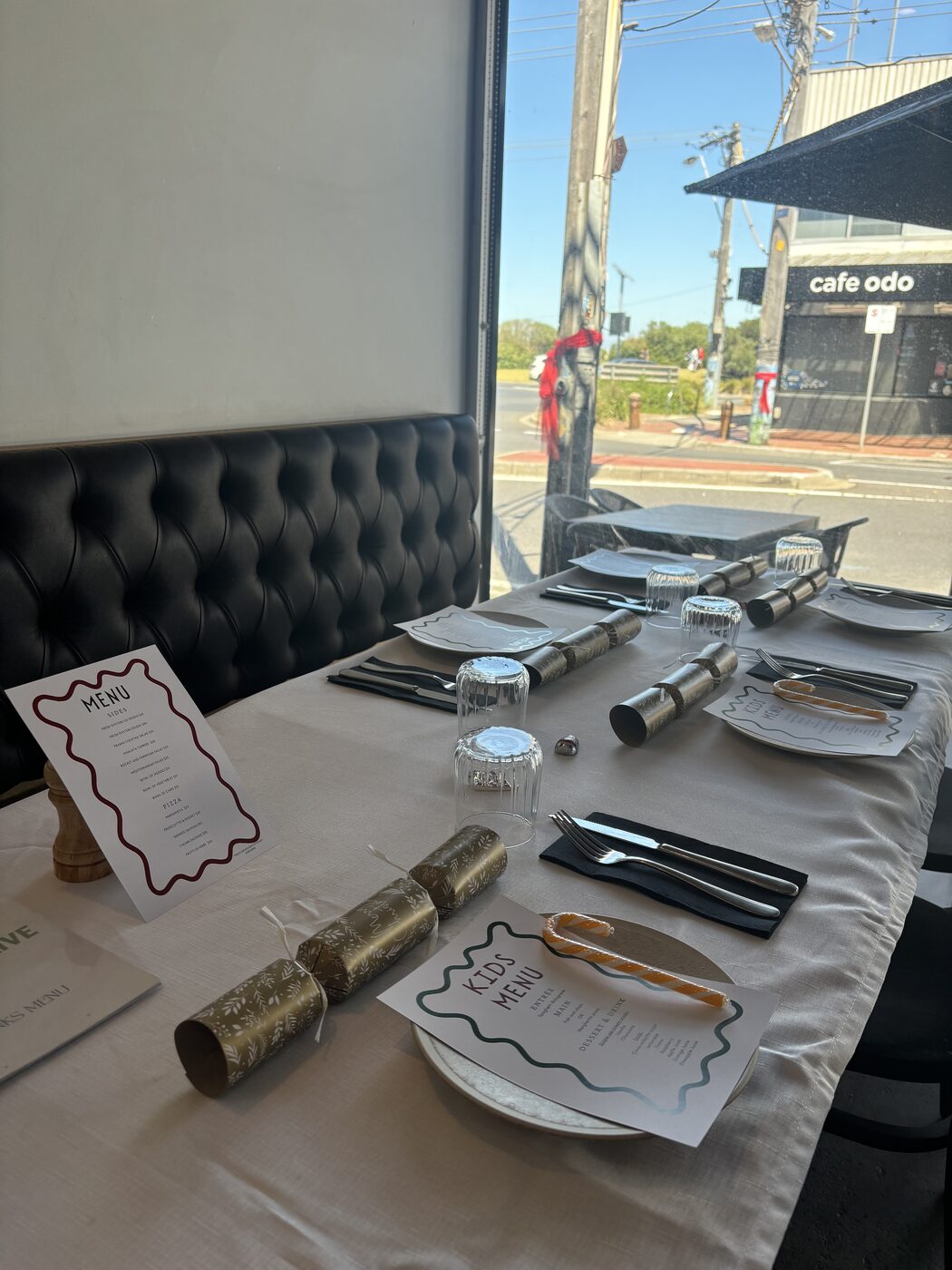 Christmas table set with crackers, kids menus and candy canes